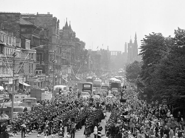 Pipe bands - Police and Military march along Princes Street.
