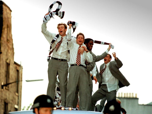 Gary Locke of Heart of Midlothian carries the Scottish Cup along Gorgie Road into Tynecastle after Hearts' 2-1 win against Rangers in 1998.
