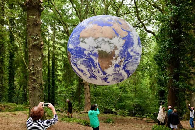 Luke Jerram's Gaia suspended in woodlands in Dorset