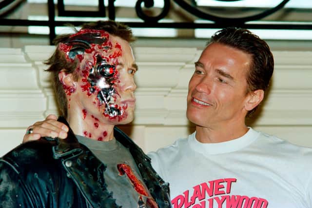 The real Arnold Schwarzenegger poses next to a waxwork of his robotic character in the movie Terminator 2 (Picture: Jacques Demarthon/AFP via Getty Images)