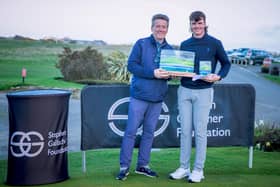 Royal Troon's Dylan Cairns is presented with the SGF Classic Trophy by Goswick Golf Club chairman Robert Cook after his win at the Northumberland venue. Picture: Martin Cairns