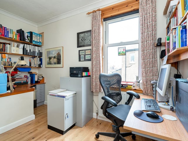 The smaller double bedroom is currently in use as a peaceful home office.