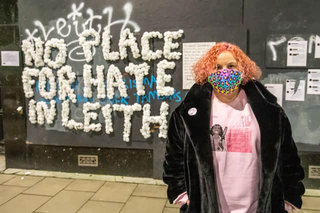 Heather Marshall, founder of Creative Electric, in front of the 'No Place for Hate in Leith' wall on Leith Walk.