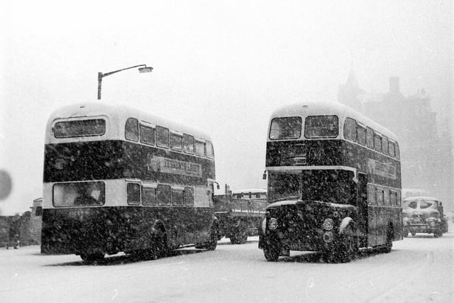 Buses struggle through the blizzard on North Bridge during a snow storm in Edinburgh in April 1968.