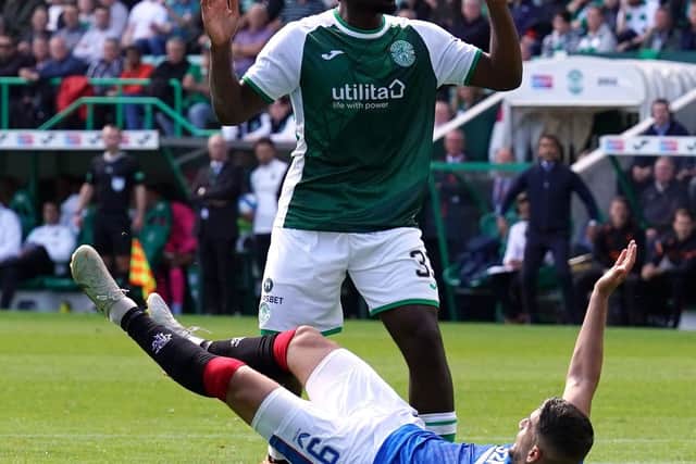 Rangers striker Antonio-Mirko Colak hits he deck after a grab by Hibs defender Rocky Bushiri, resulting in a penalty. Picture: Andrew Milligan/PA