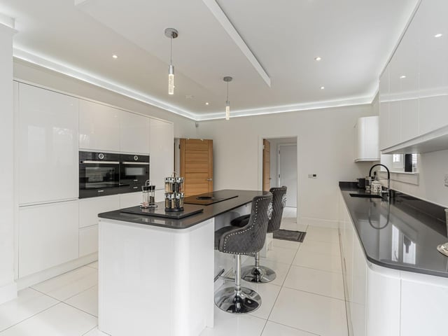 The sleek dining/ kitchen is fitted with a superb assortment of stylish units with contrasting worktops, tiling to floors and top quality integrated appliances.