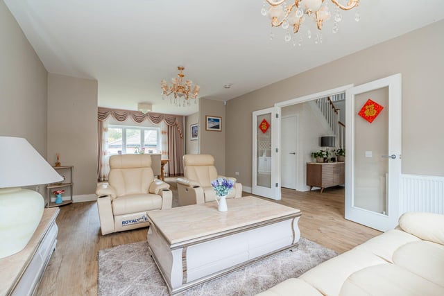 The bright and spacious reception room with high quality flooring and fresh neutral décor.