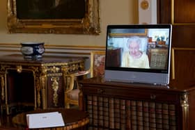 Queen Elizabeth II appears on a screen via videolink from Windsor Castle, where she is in residence, during a virtual audience at Buckingham Palace.