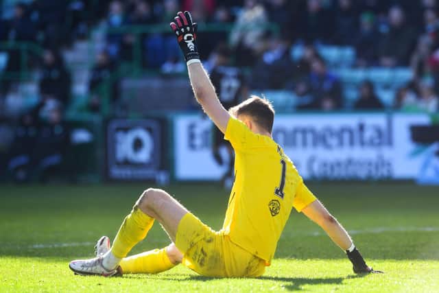 Matt Macey signals for the physio after picking up an injury in the goalless draw with Celtic