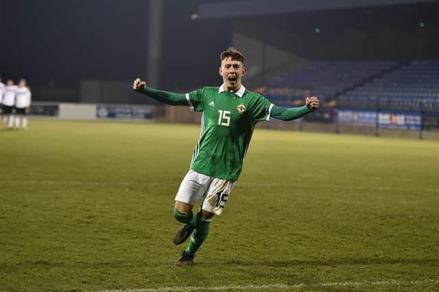 Darragh Burns celebrates scoring a penalty for Northern Ireland Under-19s against Germany