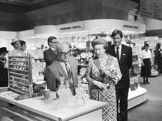 Queen Elizabeth II can be seen here chatting to Fred Lonie at the Edinburgh Crystal department whilst visiting during the 150th anniversary exhibition at Jenners department store. Year: 1988
