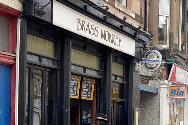 Edinburgh resident waiting to collect his pre-ordered pint at Brass Monkey in Leith Walk. (photo: Isabella Jane)