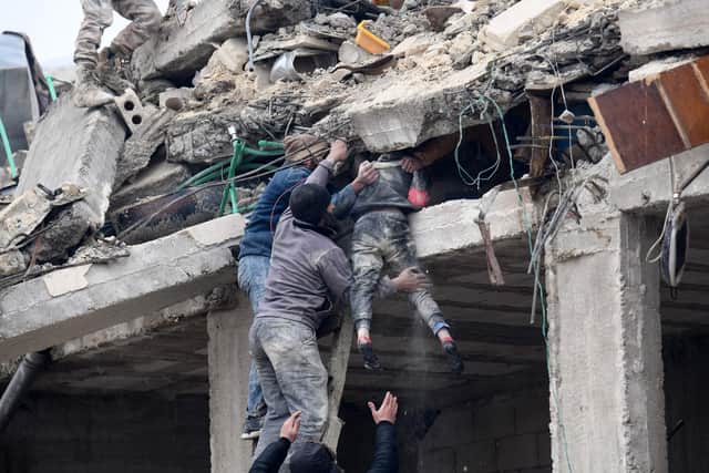 Local people in Jandaris, Syria retrieve an injured girl from the rubble of a building destroyed by the devastating earthquake (Picture: Rami al Sayed/AFP via Getty Images)