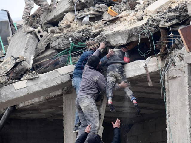 Local people in Jandaris, Syria retrieve an injured girl from the rubble of a building destroyed by the devastating earthquake (Picture: Rami al Sayed/AFP via Getty Images)