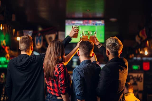 Friends watching football in the pub