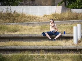 A man enjoys the sun in Holyrood Park in Edinburgh as the UK is hit by a heatwave. Picture: SWNS