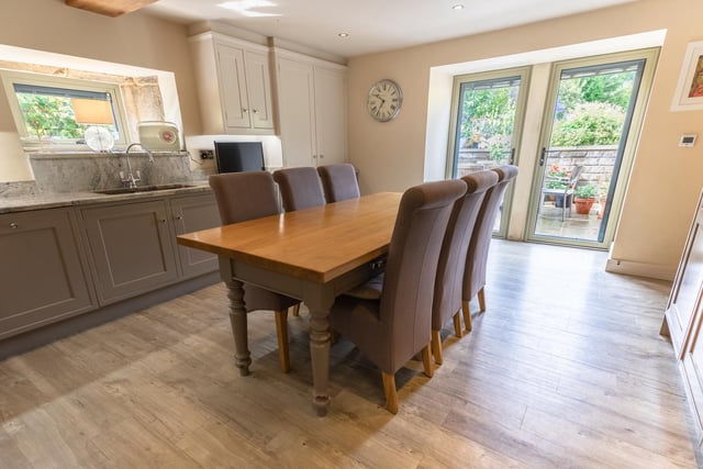 A full-size dining table fits easily into the kitchen, which also features patio doors.