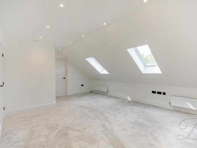 The master bedroom has access to not only a larger-than-average en suite but also a dressing room. It has two Velux roof windows.