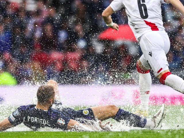 Scotland's Ryan Porteous slides on the wet pitch during a UEFA Euro 2024 qualifier between Scotland and Georgia at Hampden Park, on June 20, 2023, in Glasgow, Scotland. (Photo by Craig Williamson / SNS Group)