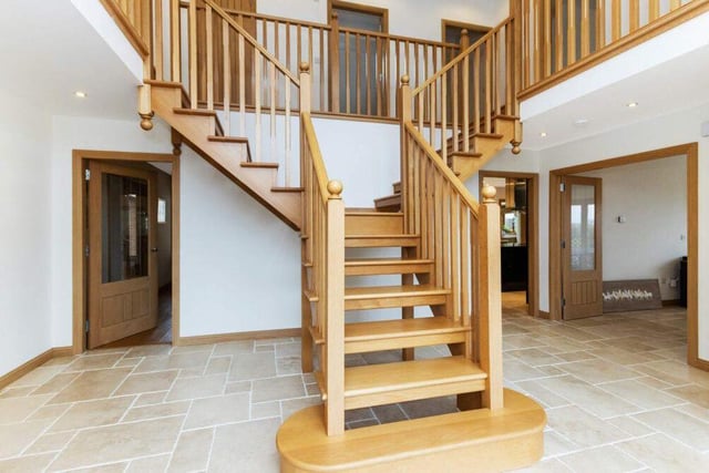A beautifully crafted wooden staircase displays the excellent workmanship throughout this family home.