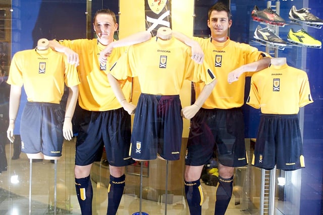 Livinagton defender David McNamee and Rangers striker Steven Thompson show off the new Scotland third kit in a sports shop front window back August 2004. McNamee won four caps, Thompson 16