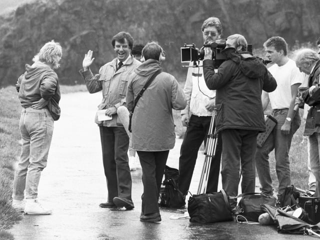 TV presenter and journalist Russell Harty with his film crew in Edinburgh on Fringe Sunday in August 1985.