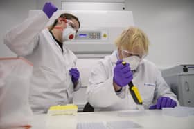 Boris Johnson carries out a test under the supervision of quality control technician Kerri Symington at biotechnology laboratory Valneva in Livingston, where they are set to start large-scale manufacturing of a Covid-19 candidate vaccine (Picture: Wattie Cheung/pool/AFP via Getty Images)