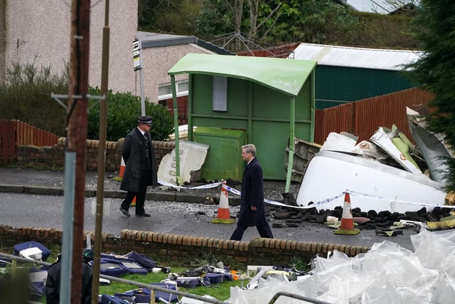 Colin Firth was pictured on Wednesday by the PA news agency walking through a scene that appears to be set shortly after the debris from Pan Am flight 103 collided with the town of Lockerbie, killing 11 people on the ground.