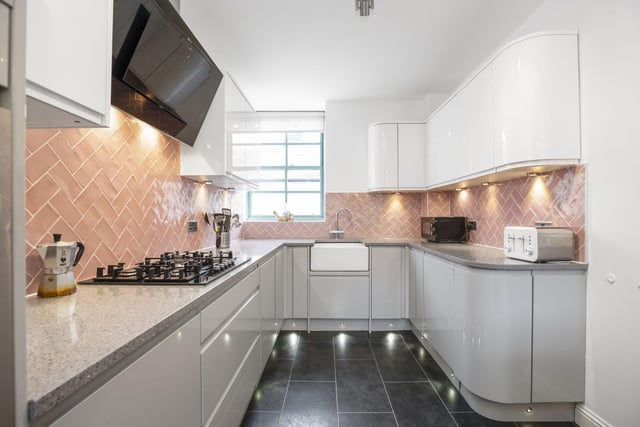 The newly decorated dining sized kitchen that benefits from an island, Belfast sink, dishwasher, oven, 5 ring gas hob and fan
