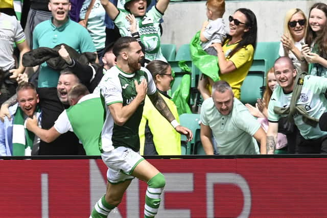 Martin Boyle races away beating the Hibs badge after equalising in the dying seconds against rivals Hearts. Picture: SNS
