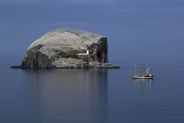 The tall ship Pelican of London is anchored alongside the Bass Rock off the East Lothian coast during a tour around the coast of Britain.