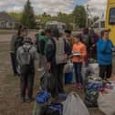 Evacuees from the town of Vovchansk arrive at an evacuation point in Kharkiv region on May 12 amid the Russian invasion of Ukraine. Thousands of people have been evacuated from border areas in Ukraine's Kharkiv region, as Russia kept up constant strikes on a key town as part of a cross-border offensive (Photo by ROMAN PILIPEY/AFP via Getty Images)
