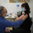 Linda Ella receiving her Covid booster vaccine jab at Copes Pharmacy in Streatham, south London.
