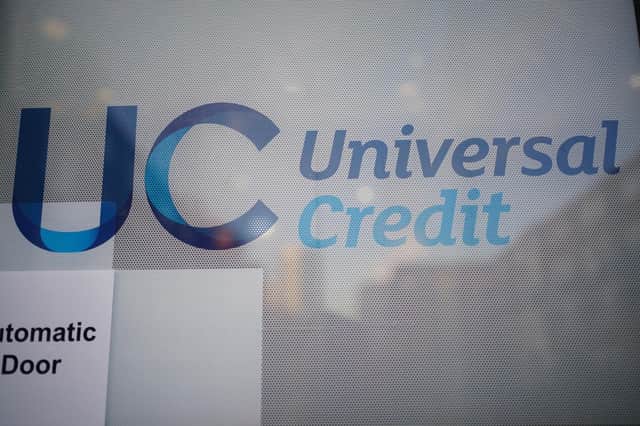 A Universal Credit sign on a door of a job centre plus in east London. PA.