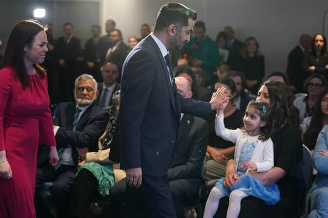 Humza Yousaf gets a high-five from his daughter Amal after it was announced he had won the election to be SNP leader (Picture: Andrew Milligan/PA)