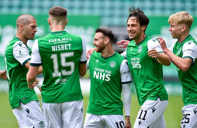 Martin Boyle is mobbed by his Hibs team-mates after opening the scoring.
