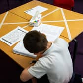 Social distancing measures as a child studies on a marked table at Kempsey Primary School in Worcester.