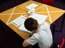 Social distancing measures as a child studies on a marked table at Kempsey Primary School in Worcester.