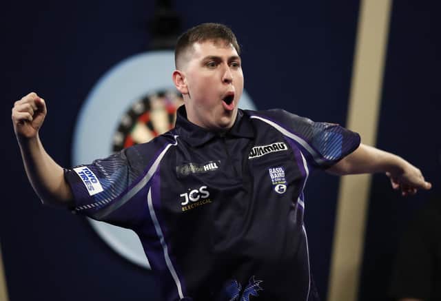 William Borland of East Calder reacts to his stunning nine-dart finish during his first round match against Bradley Brooks at Alexandra Palace