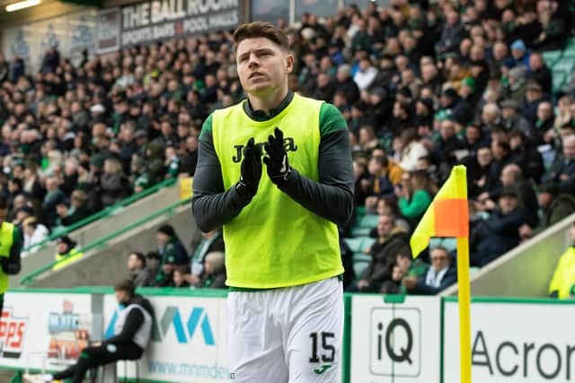 Nisbet applauds the Hibs fans as he warms up during the 6-0 victory over Aberdeen, shortly after U-turning on a January move to Millwall