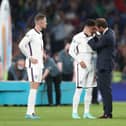 England manager Gareth Southgate consoles Jadon Sancho following defeat in the penalty shoot-out after the UEFA Euro 2020 Final at Wembley Stadium, London.