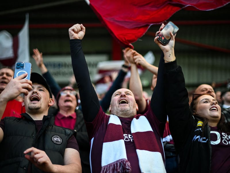 Hearts fans react before the start of the match  (Photo by ANDY BUCHANAN / AFP via Getty Images)