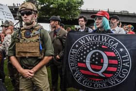 A person holds a banner referring to the Qanon conspiracy theory during a alt-right rally in Portland, Oregon (Photo: Stephanie Keith/Getty Images)
