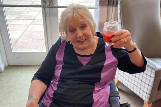 Joyce, with a well earned drink after completing her walking challenge.
