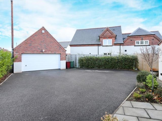 Moving back outside, and this photo shows the lengthy, private driveway at the front of the Shirland property, and also the detached double garage. No problems with parking here.