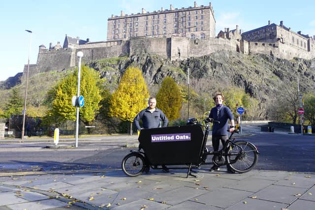 Callum (left) and Alex (right) with their e-cargo bike delivering oat milk around Edinburgh.