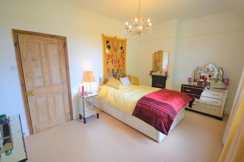 Bedroom, a spacious and attractively presented double bedroom with a pleasant view from a front facing UPVC double glazed window, having a feature cast iron fireplace with tiled hearth, and a built in storage cupboard with hanging rail and light.