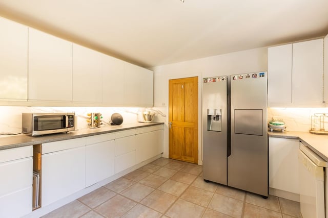 The well appointed kitchen enjoys a leafy aspect to the rear and is fitted with a range of sleek white wall and base units as well as American style fridge / freezer, Induction Range cooker (with 2 ovens), Economical washing machine included in the sale.