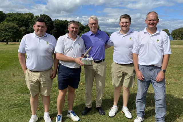 Donald Livingstone, Mark Kernaghan, BLGS captain George Reid, Drew McIntosh and Kevin Cattanach show off the trophy.