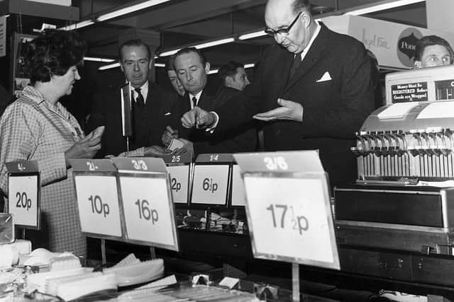 On the day of the official change to decimalised currency, Lord Fiske, chairman of the Decimal Currency Board, makes a purchase at a Woolworths store (Photo: George W. Hales/Fox Photos/Getty Images)